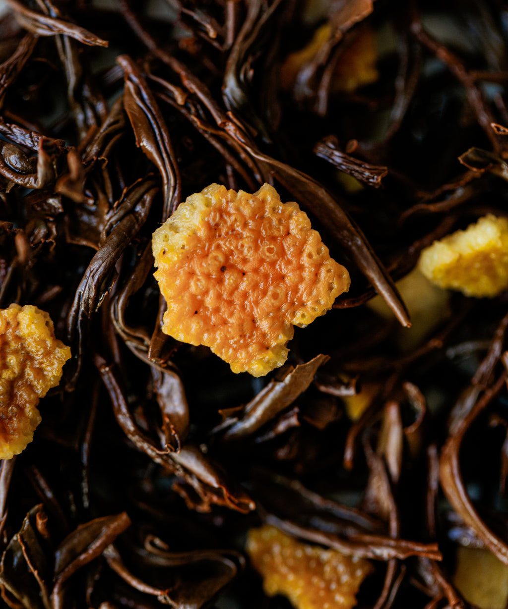 Cup of Yuzu & Gold Guanyin showing amber liquor with citrus aromatic notes