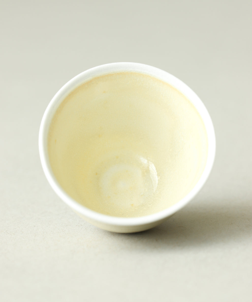 Yellow Bamboo Tea Cup in hand, understated yellow glaze on thin porcelain