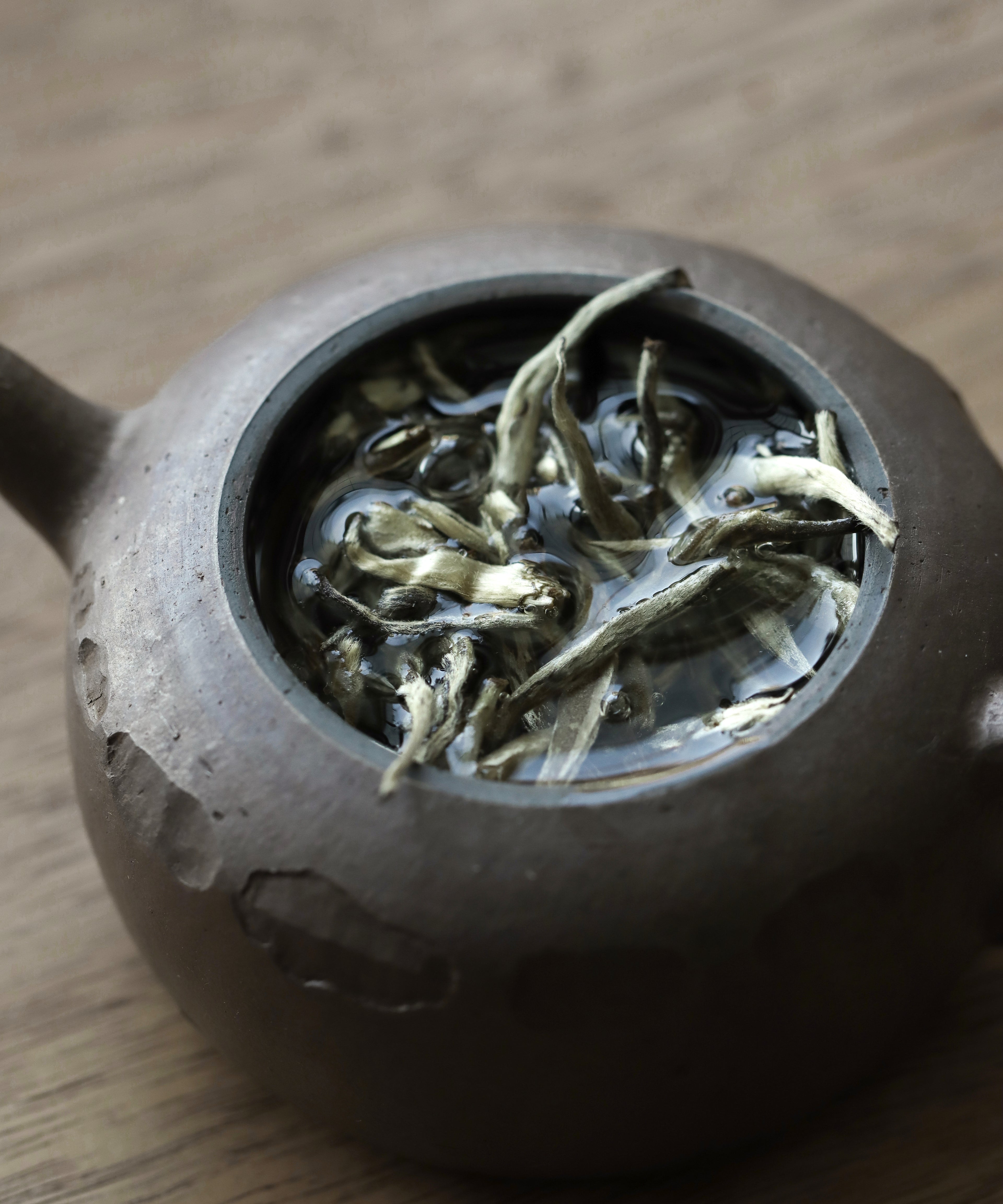 Silver Needle pressed cake detail showing the dense pack of silver buds
