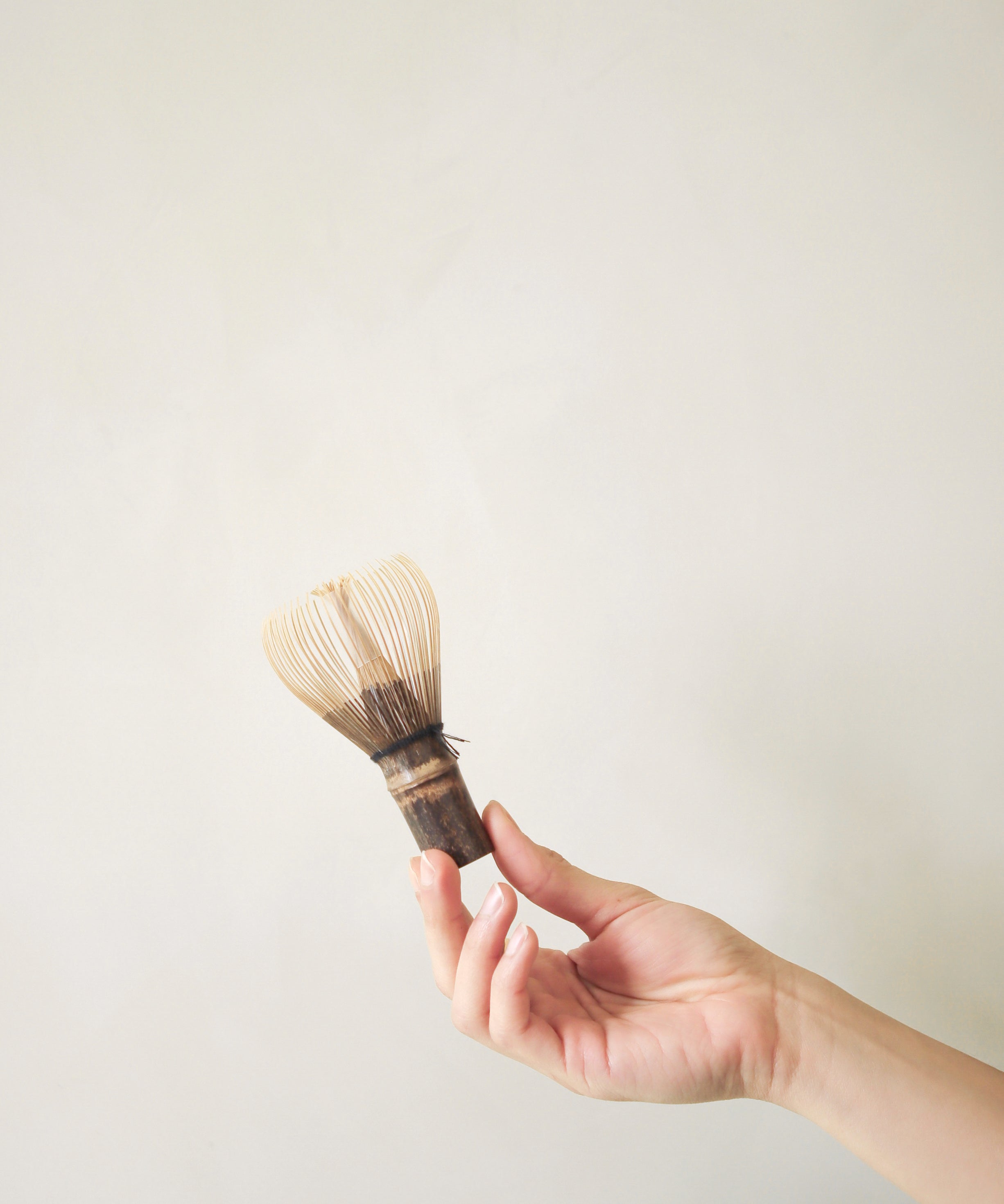 Using bamboo matcha whisk chasen to prepare Japanese matcha latte